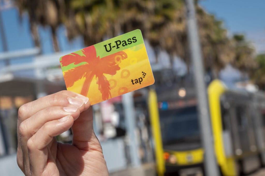 Student holding an LA Metro U-Pass card.