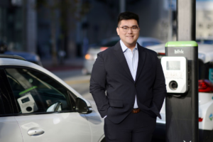 Dylan Di, standing in front of an EV charging station. (Photo: Qinhe Wang)