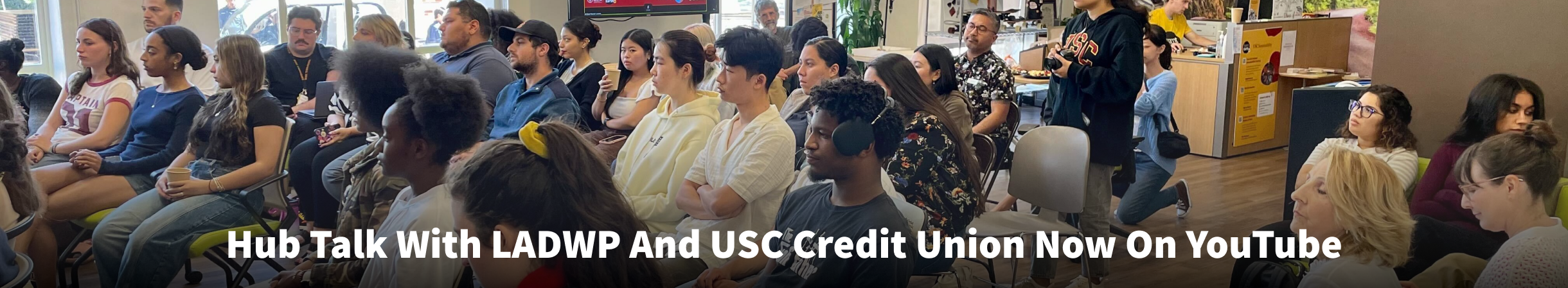 A crowd at the USC Sustainability Hub with the text "Hub Talk With LADWP And USC Credit Union Now On YouTube."