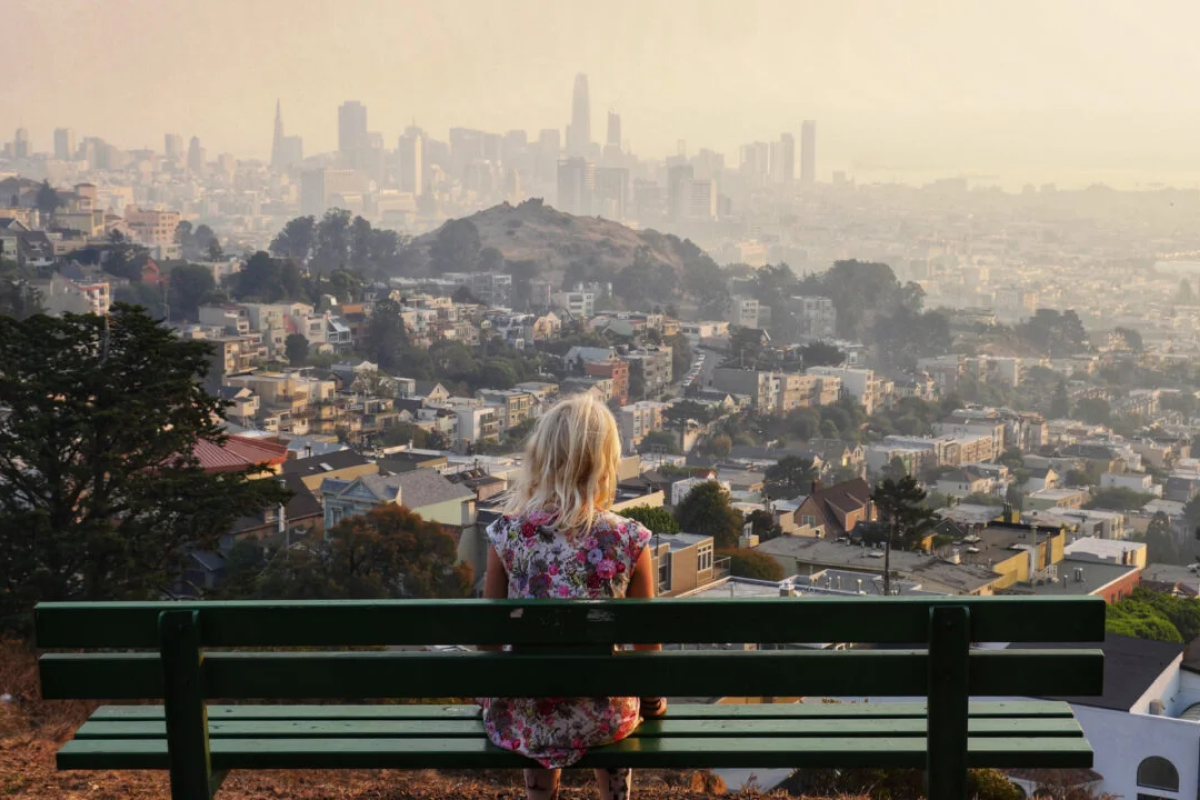 Young person looking at polluted sky.