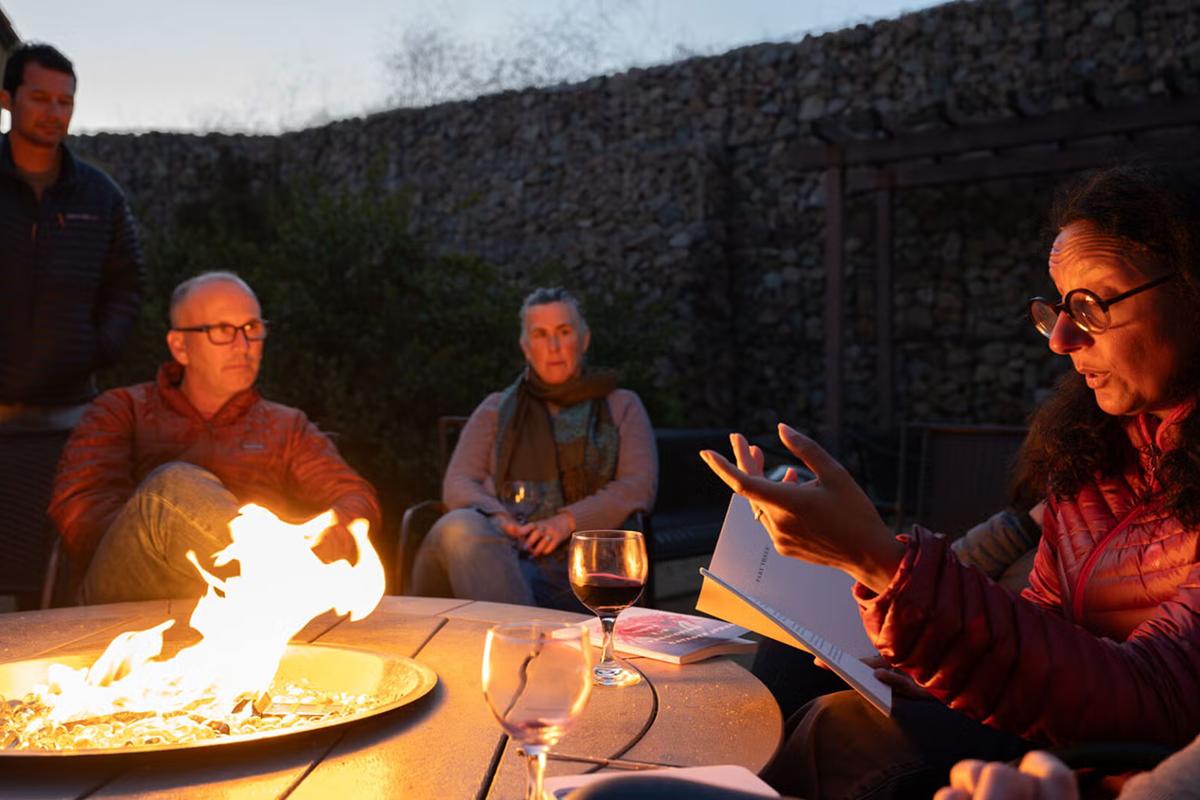 Storymakers fellows often gather around the Wrigley Marine Science Center fire pit at night to share ideas, stories, and encouragement. In 2023, fellow Madhur Anand captivated the group with a reading from her recently published poetry. (Photo: Nick Neumann/USC Wrigley Institute)