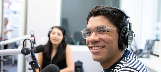 Two podcasters pose for a picture at the Annenberg Media Center.