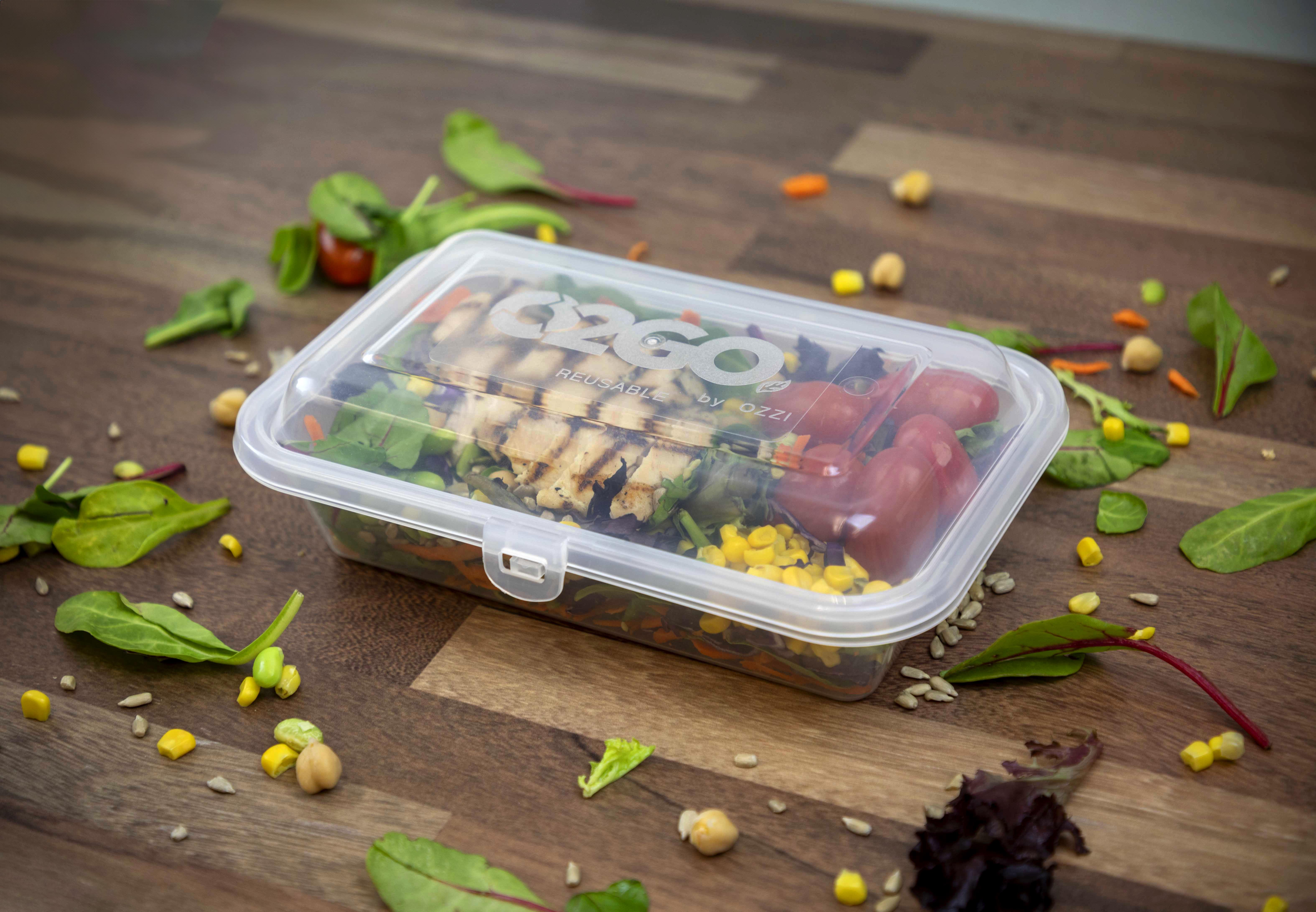 An OZZI O2GO reusable food container with a meal inside.
