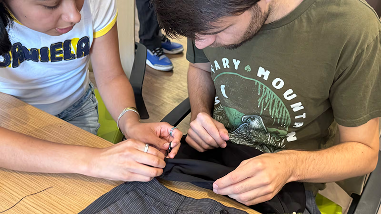 Students learn to repair clothes at the Sustainability Hub to celebrate Green Week. (Photo by Sean Campbell)
