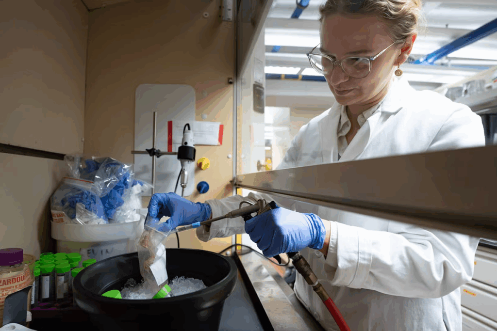 2025 Wrigley Institute Graduate Fellow Jenna Dilworth uses an airbrush to remove tissue from a coral fragment so it can be further processed for molecular analyses (Nick Neumann/USC Wrigley Institute).
